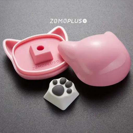 ZOMOPLUS white-grey kitty paw keycap displayed alongside its cat-themed storage box, ideal for keyboard enthusiasts.