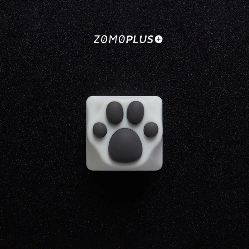 ZOMOPLUS kitty paw keycap in white-grey, viewed from above, with soft, bouncy silicone and durable ABS construction.