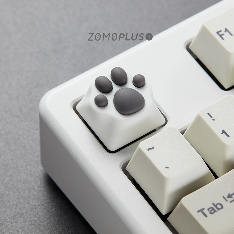White-grey ZOMOPLUS kitty paw keycap shown from a side angle, installed on a keyboard, combining cute design with a high-quality typing experience.