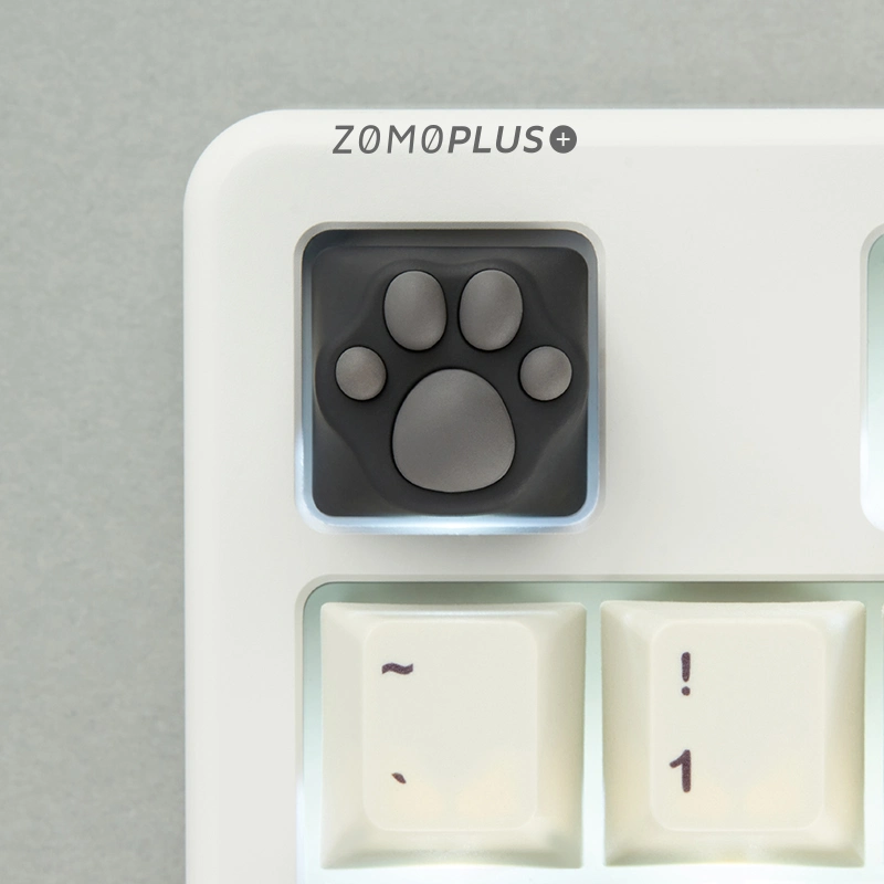 This ZOMOPLUS keycap showcases its playful design from above, perfect for any cat lover's keyboard setup!