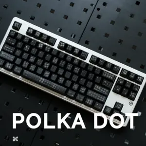 Complete mechanical keyboard with black polka dot keycaps installed, white keyboard frame, professional gaming setup