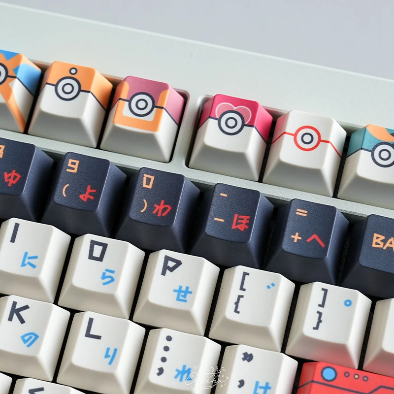 Pokemon keycaps number row showing colorful Pokeball designs with Japanese katakana text on mechanical keyboard keys
