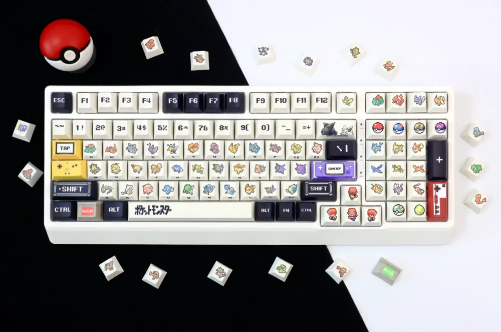 Complete Pokemon keycap keyboard layout with authentic Pokeball prop and scattered Pokemon character keycaps