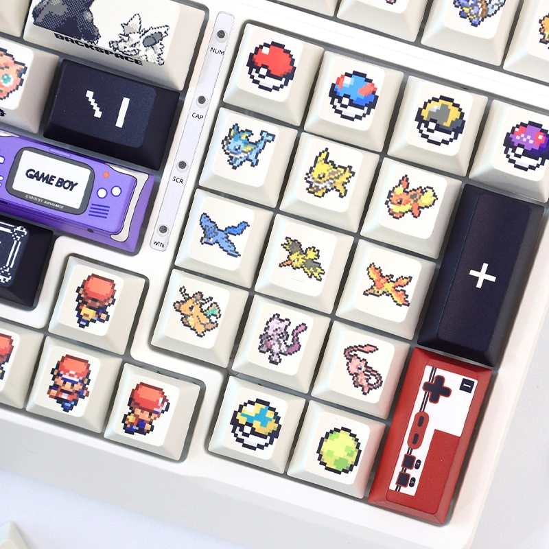Close-up Pokemon keycaps showing purple Game Boy key, black SHIFT key and various pixel Pokemon characters