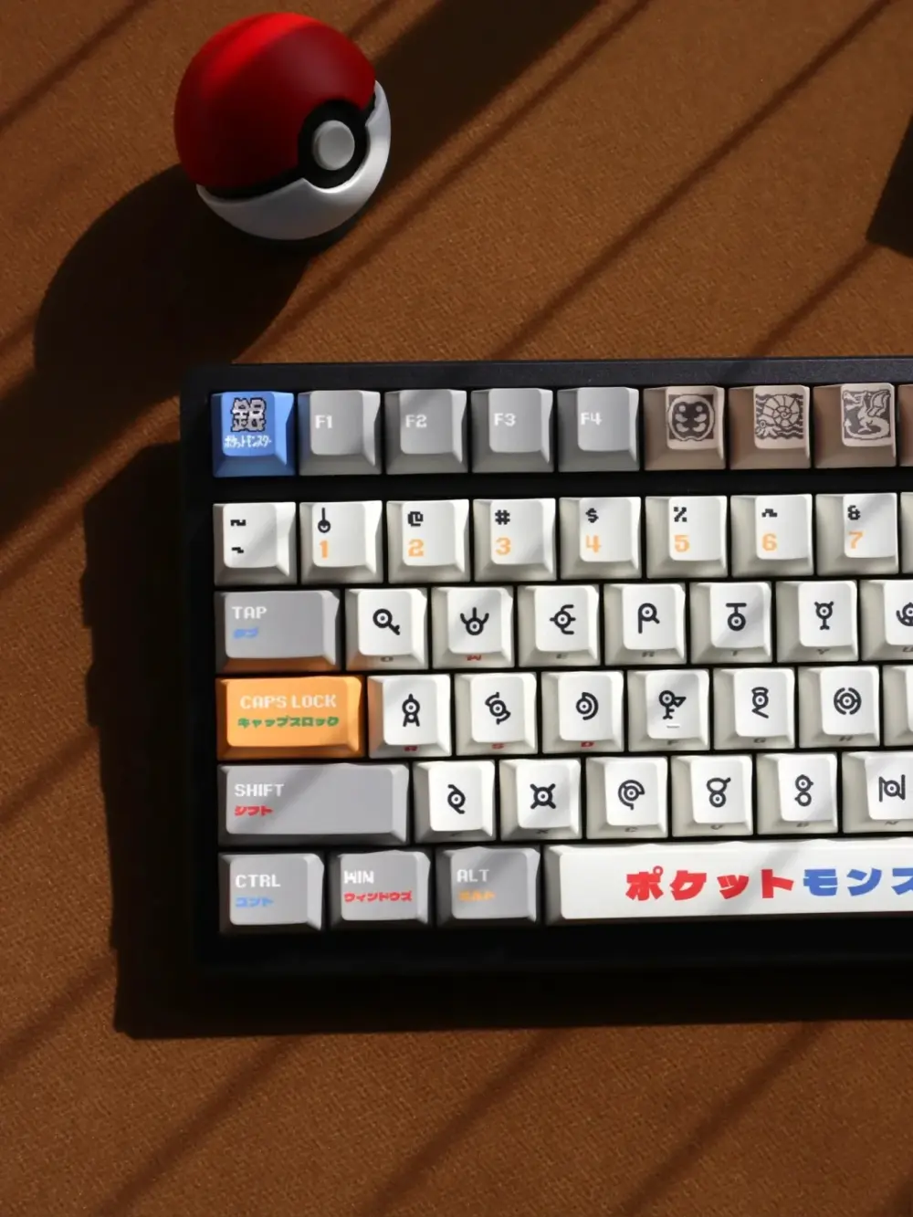 Pokemon Unown keycaps lifestyle shot with Pokeball showing authentic alphabet symbols cherry profile keyboard