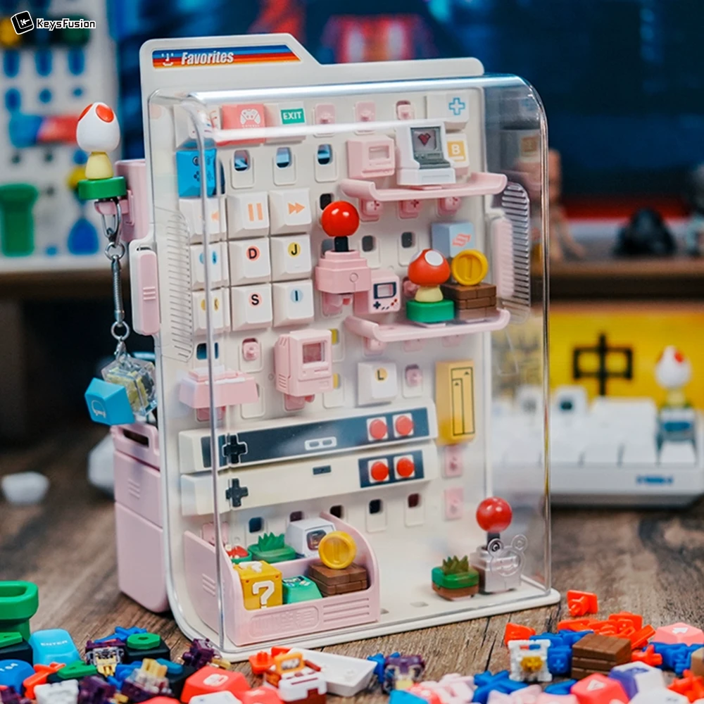 Aesthetic Keycap Collection Display | Pink Vertical Storage Solution Pink vertical keycap storage case with transparent dust cover displaying cute gaming-themed keycaps and retro gaming accessories.