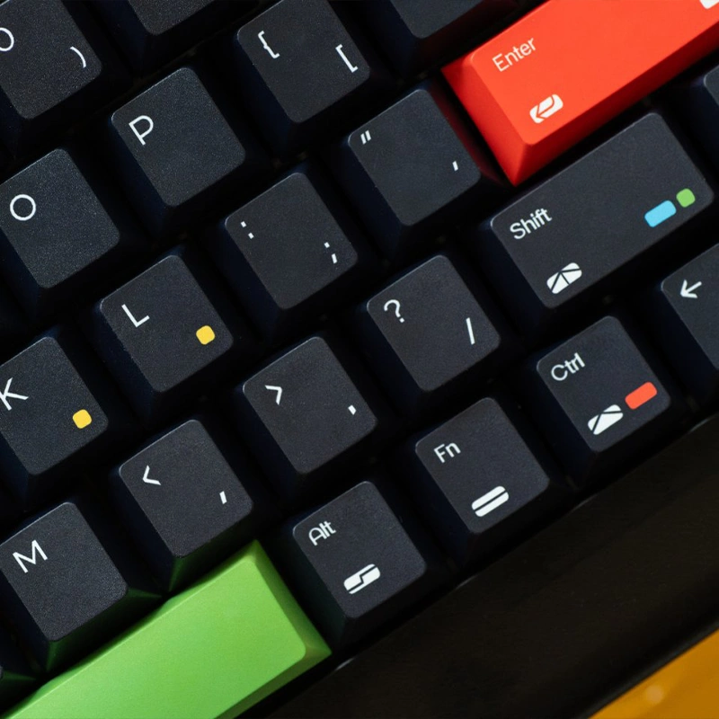 Close-up of black keycaps featuring multicolored dots and red Enter key detail