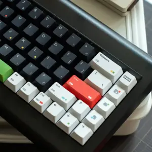 Black and white keycaps with red Enter key and green spacebar detail