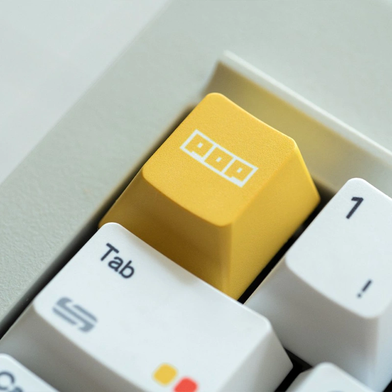 Yellow accent keycap with white legend among white rainbow dot Cherry profile keycaps