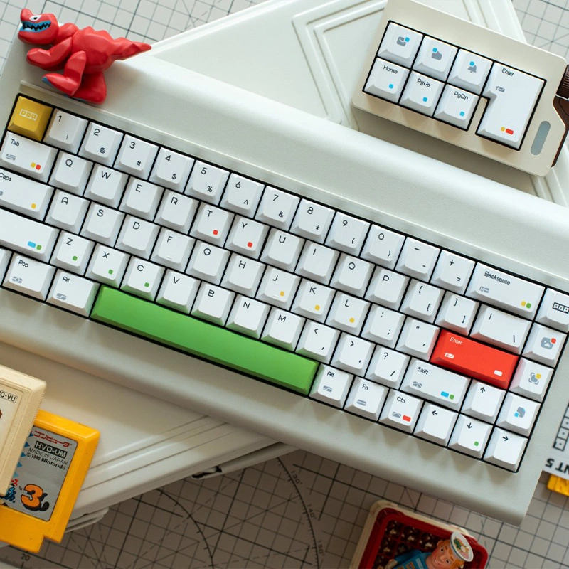 White mechanical keyboard with green spacebar and red Enter key in retro setup