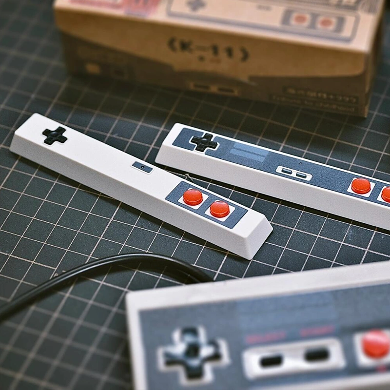 Two controller spacebar keycaps comparison, white and white-grey variants on keyboards, retro gaming collection