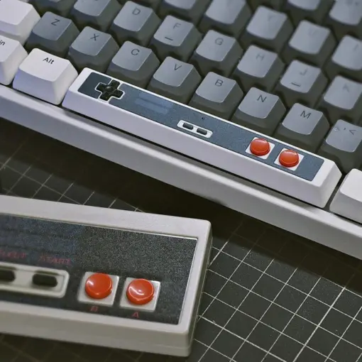 Retro Gaming Spacebar Keycap Installed on Keyboard Retro Gaming Spacebar Keycap on a gray mechanical keyboard, showcasing D-pad and red buttons with retro charm.