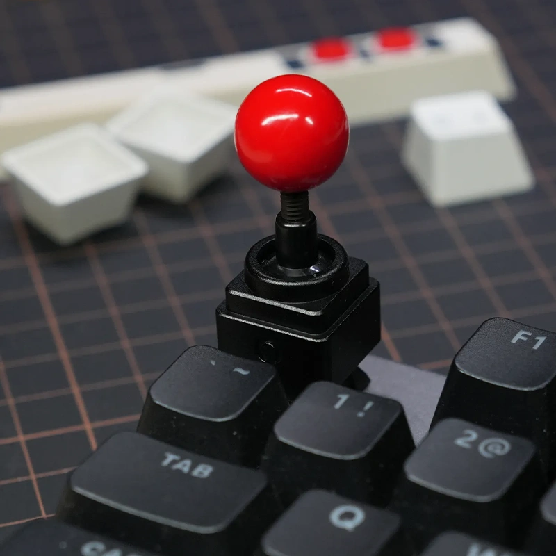 Retro Joystick Metal Artisan Keycap | Black High Profile Edition Red-topped joystick artisan keycap on black mechanical keyboard on ESC key.