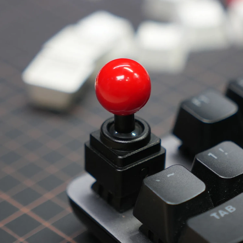 Retro Joystick Metal Artisan Keycap | Black Low Profile Edition Close-up of black metal joystick keycap with bright red ball top.
