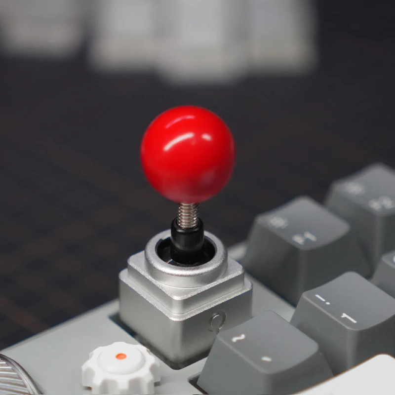 Retro Arcade Joystick Artisan Keycap High Profile Arcade-style design artisan keycap against gray keycaps is installed on mechanical keyboard.