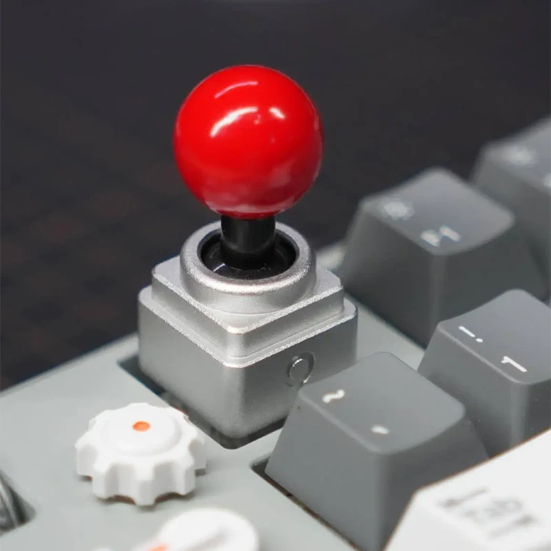 Retro Arcade Joystick Artisan Keycap | Mechanical Keyboard Gaming Accessory Red-topped metal joystick artisan keycap installed on mechanical keyboard, featuring silver CNC aluminum base.