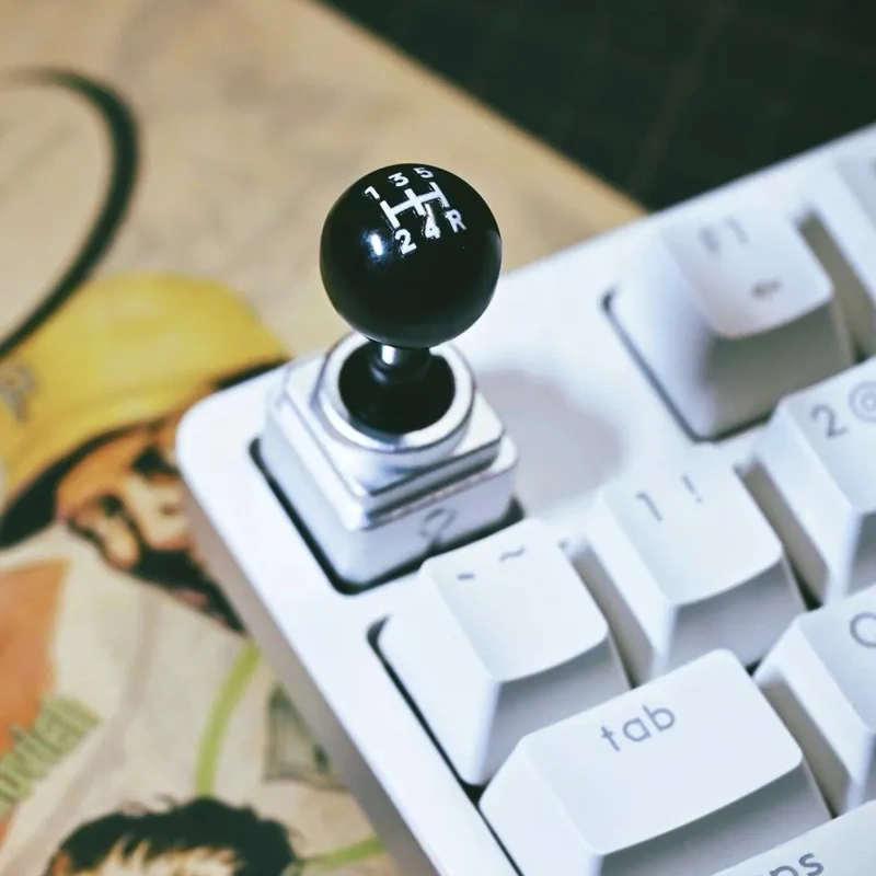 Retro Joystick Artisan Keycap | Gear Shift Edition Black gear shift pattern ball top on silver joystick keycap base.