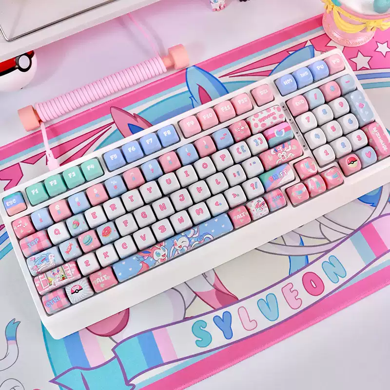 Full Sylveon-themed PBT keycaps displayed on matching Sylveon deskmat featuring ribbon designs and pastel colors.