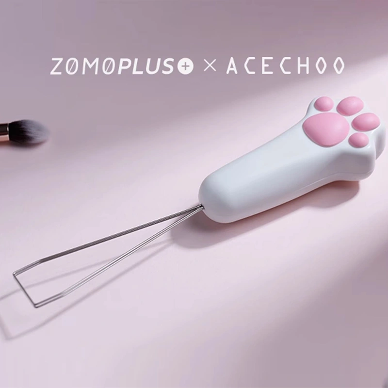 White cat paw keycap puller with wire tool and pink paw detail