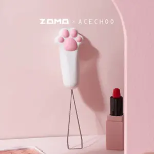 Cat paw keycap puller standing upright as desk decoration with pink background
