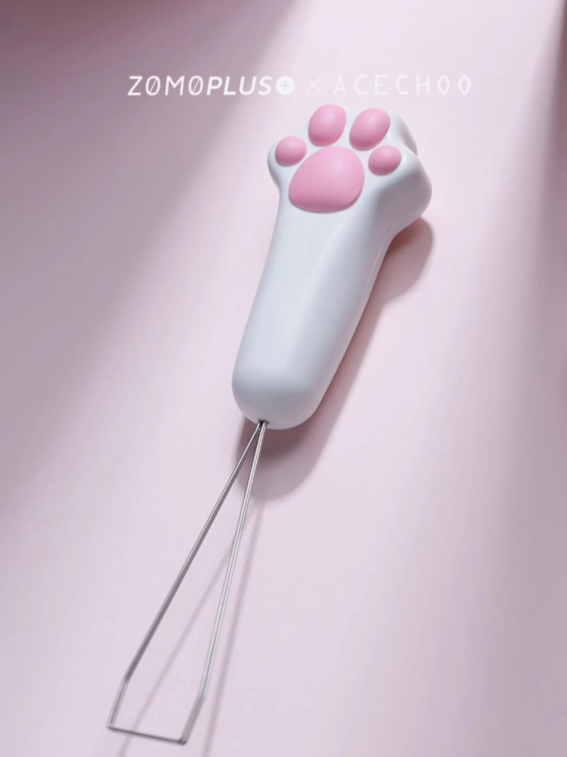 Cute cat paw keycap puller with wire tool on soft pink backdrop