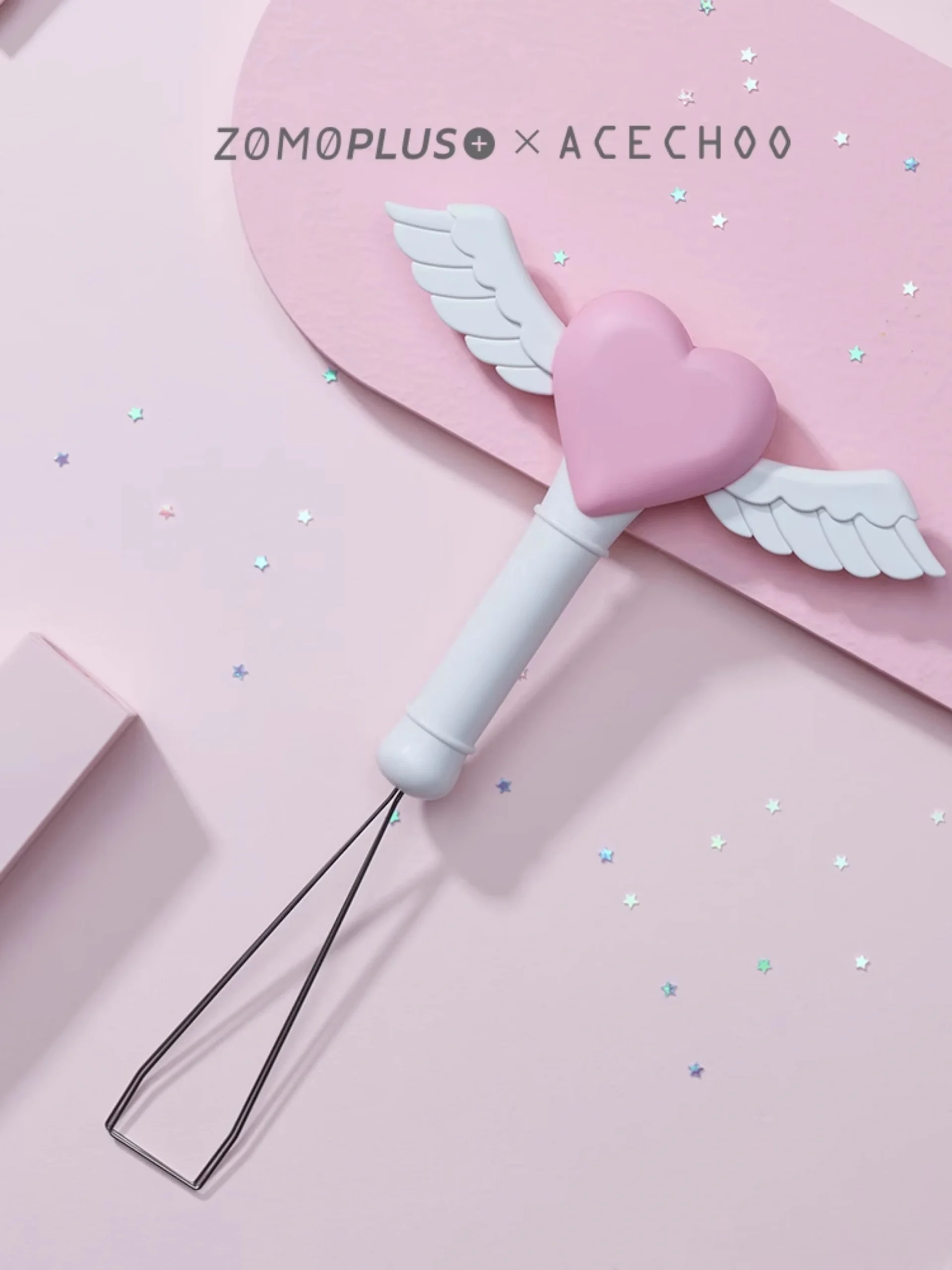 Cute fairy wand keycap puller with heart and wings on pink backdrop