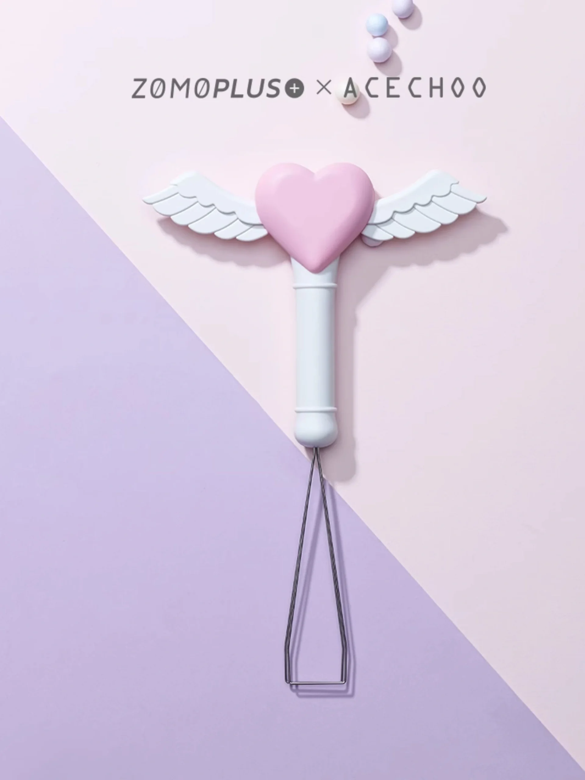 Pink heart fairy stick keycap puller with white angel wings flatlay