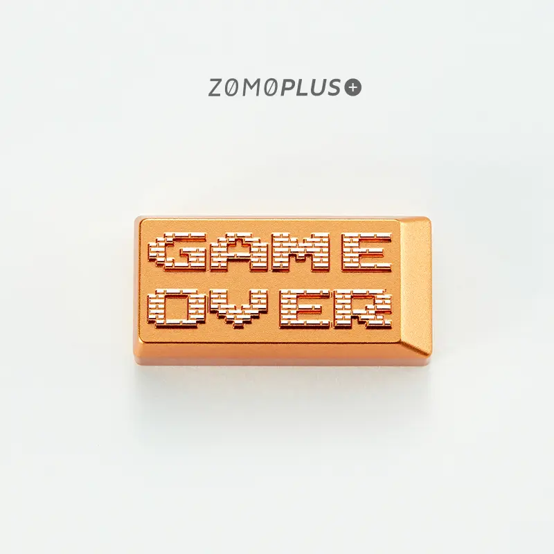 Anodized gold aluminum keycap with detailed Game Over pixel carved text closeup