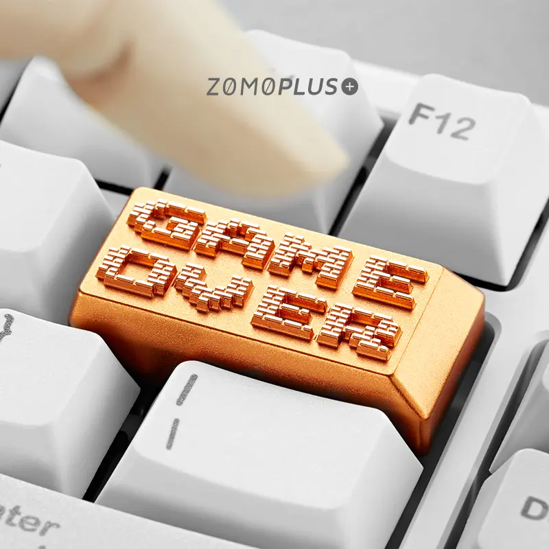 Game Over aluminum artisan keycap installed between white keycaps showing premium finish