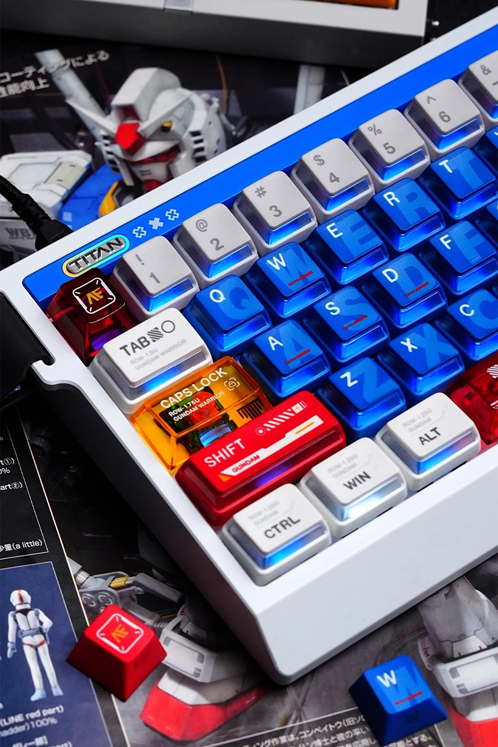 Gundam Nuclear Power & Cherry Profile Side-lit Keycaps Gundam side-lit keycaps showing translucent blue alpha keys, orange caps lock, red shift key with RGB glow effects and Gundam mecha figure in background