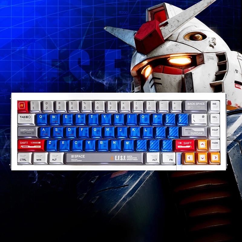 Compact 65% Gundam keyboard layout with blue alphas, grey modifiers, and orange arrow cluster on white case