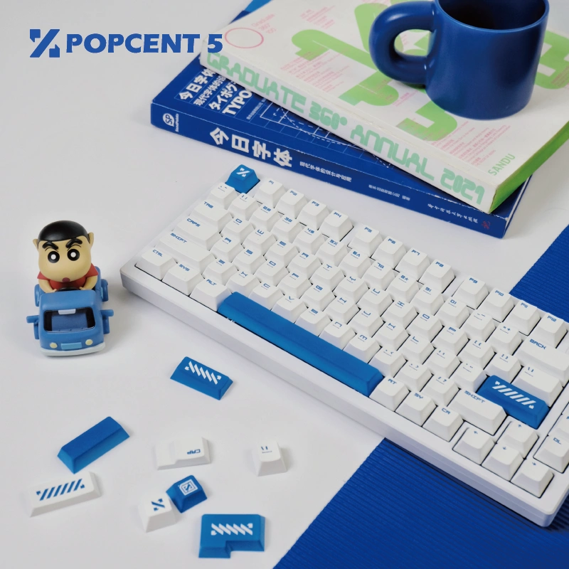 White mechanical keyboard with blue keycaps and accent keys on desk setup