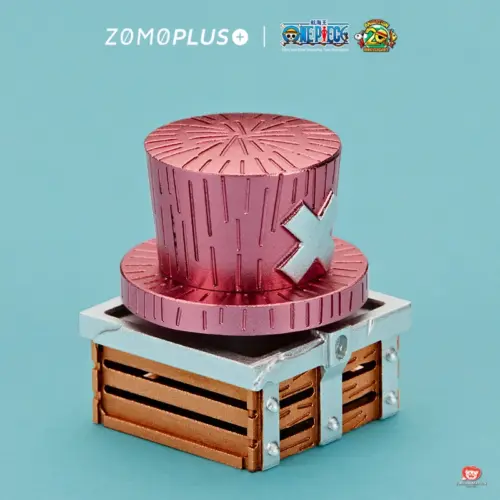 Angled view of Chopper pink hat keycap showing cross symbol and wooden treasure chest base with metal rivets