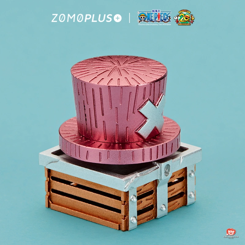 Angled view of Chopper pink hat keycap showing cross symbol and wooden treasure chest base with metal rivets