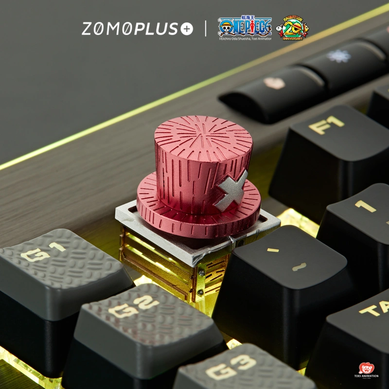 Chopper artisan keycap on dark mechanical keyboard with yellow accents displaying pink rotating hat feature