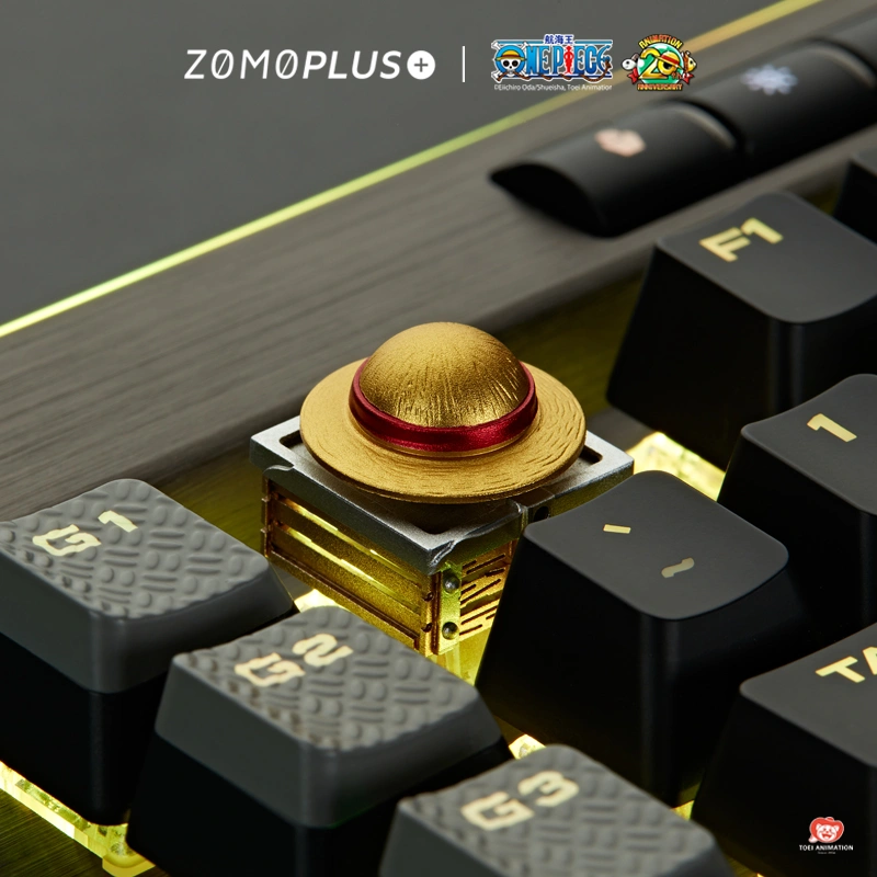 One Piece straw hat keycap on black and gold themed mechanical keyboard