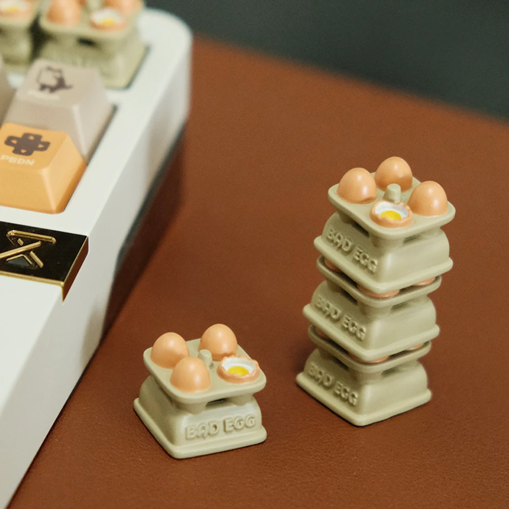 Egg tray artisan keycaps next to mechanical keyboard showing MX compatibility, featuring hand-painted miniature eggs