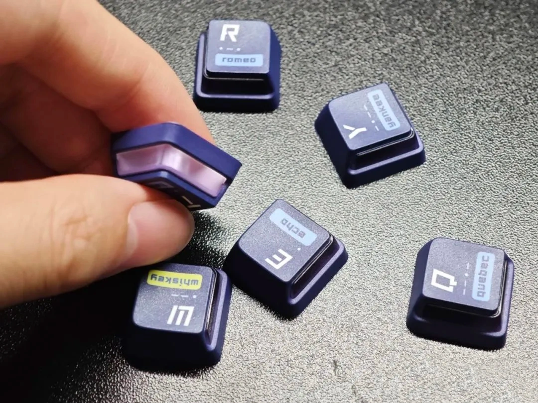 Nuclear Power Profile Keycaps: The RGB Innovation Guide (2026) Hand holding Nuclear Power Profile keycap showing L-shaped PC window layer wrapped around PBT outer shell