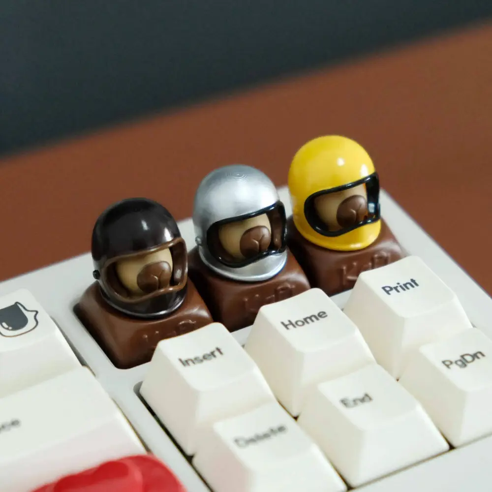 Three Helmeted Capybara Custom Resin Keycaps Close-up of three helmeted capybara artisan keycaps installed on a mechanical keyboard with white keys.