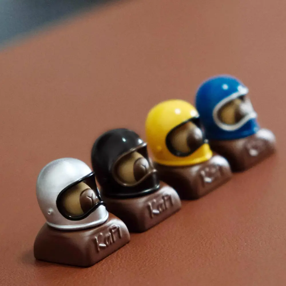 Cute Helmeted Capybara Keycaps Lineup Lineup of cute helmeted capybara custom resin keycaps showing different helmet color variations.