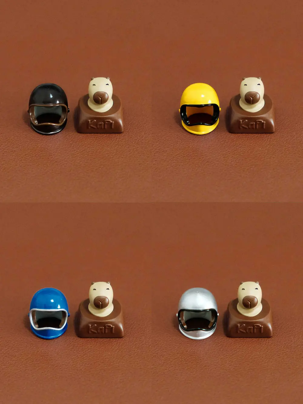 Cute Helmeted Capybara Magnetic 3D Printed Custom Resin Keycaps Set of four capybara artisan keycaps with magnetic helmets in black, yellow, blue, and silver colors.