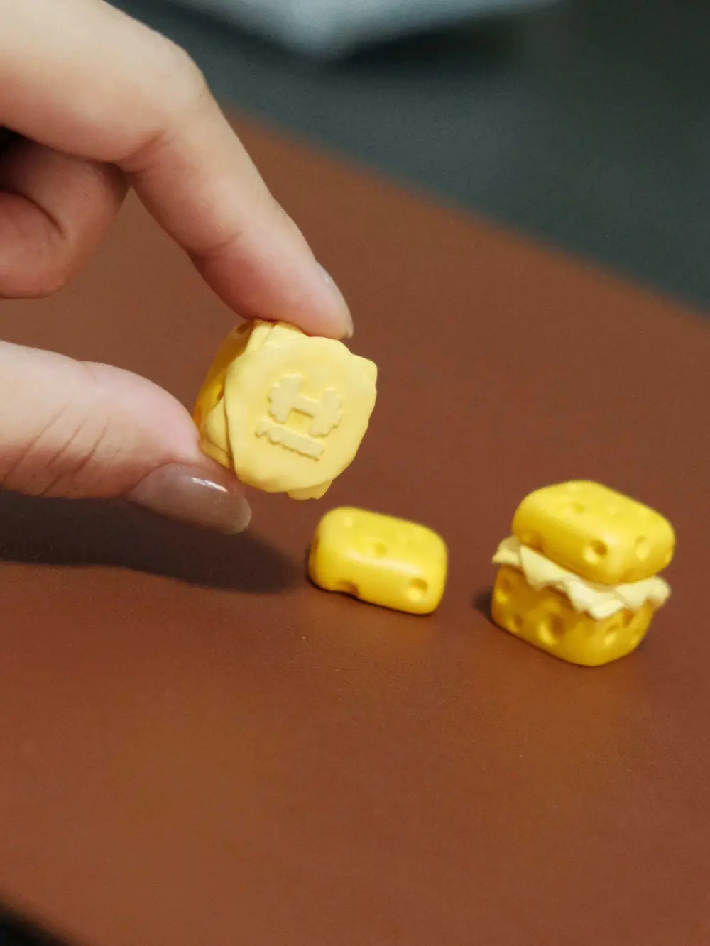 Cute Cheese Keycap Detached Magnetic Top Disassembled cute cheese 3D printed artisan keycap showing magnetic parts on a table.
