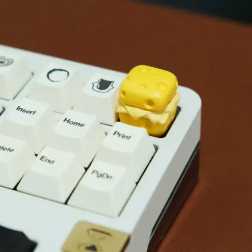 Cute Cheese Artisan Keycap Installed Side view of cute cheese 3D printed artisan keycap on a keyboard with white keycaps.