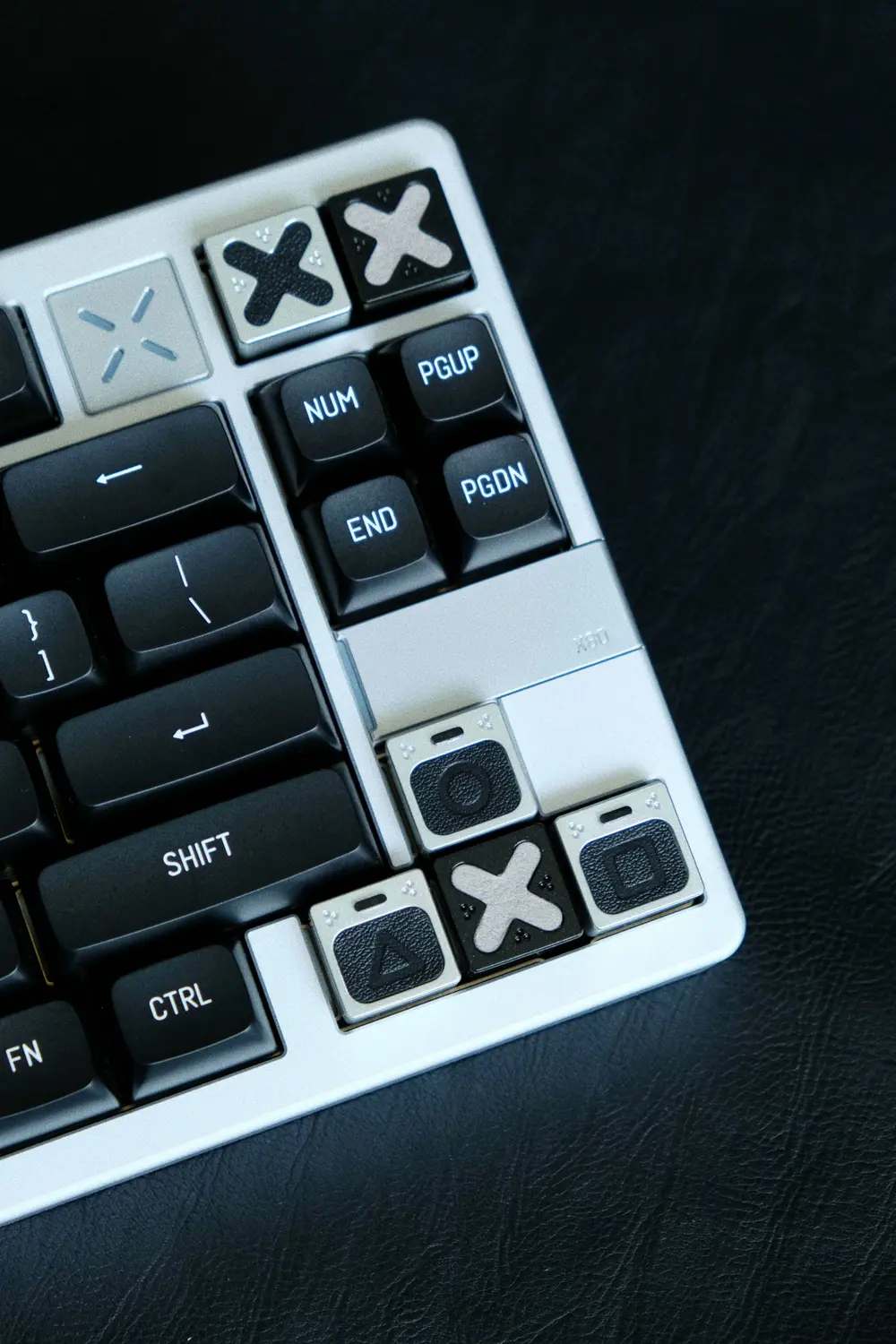 Genuine Leather PlayStation Symbols Artisan Keycaps Close-up of genuine leather PlayStation keycaps with triangle, circle, cross, and square symbols on a keyboard.