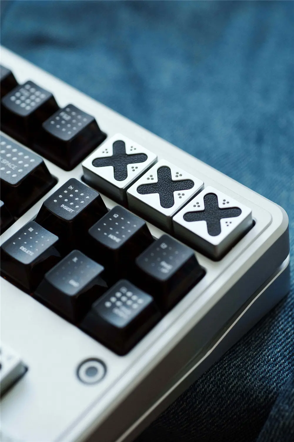 Genuine Leather Cross Symbol Artisan Keycaps Genuine leather PlayStation keycaps featuring the cross symbol with metallic finish on a keyboard.