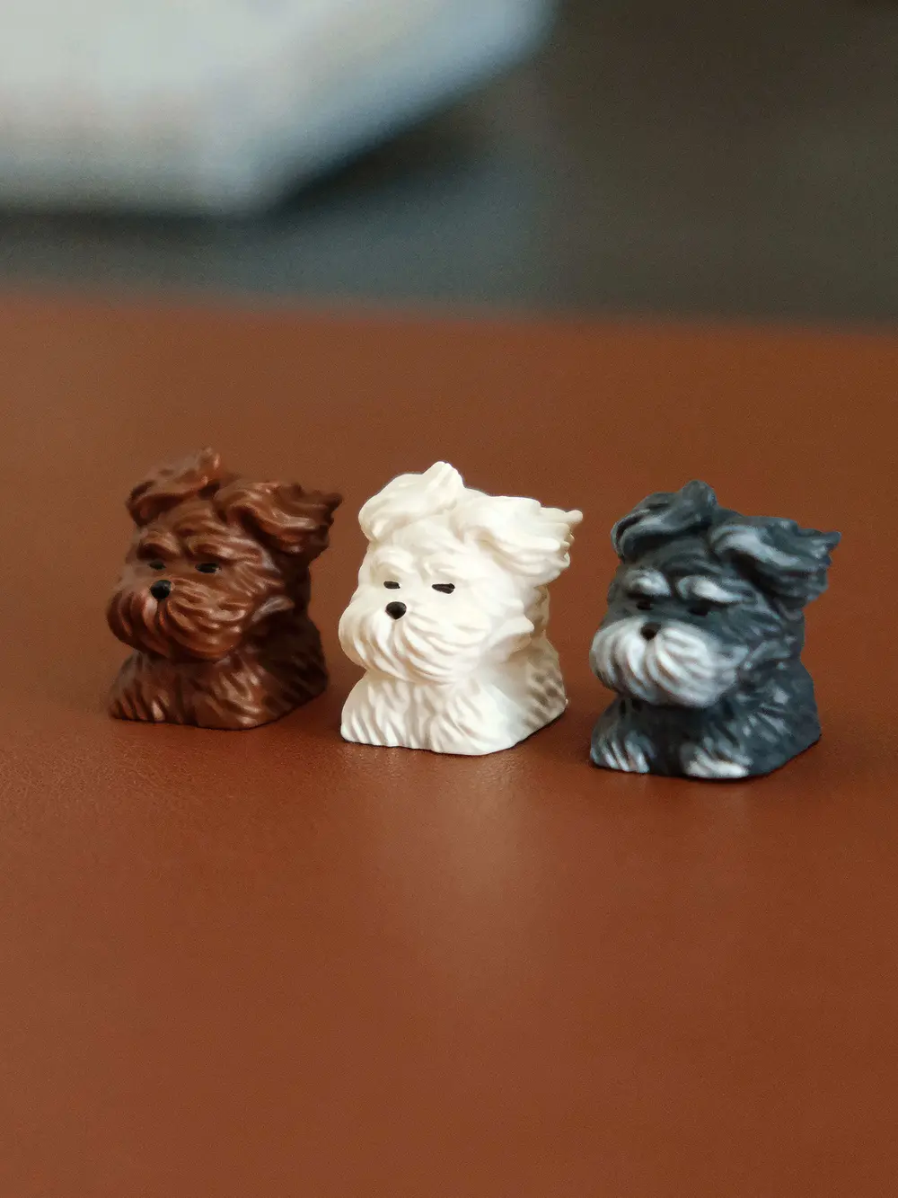 Brown, white, and grey cute puppy keycaps with wind-swept fur details made of resin.