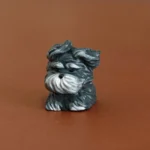 Front view of grey resin artisan keycap featuring a cute puppy face with windswept fur styling.