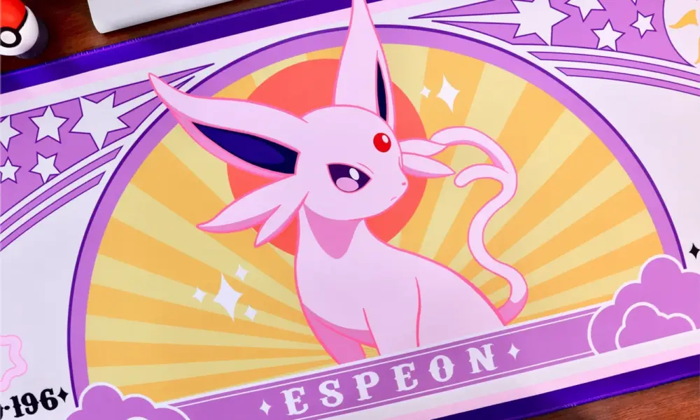 Pink Espeon character illustration on a purple and orange gaming desk mat with stars.