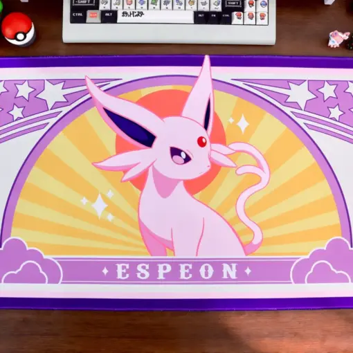 Espeon gaming desk mat with pink and purple art nouveau design on a wooden desk setup.