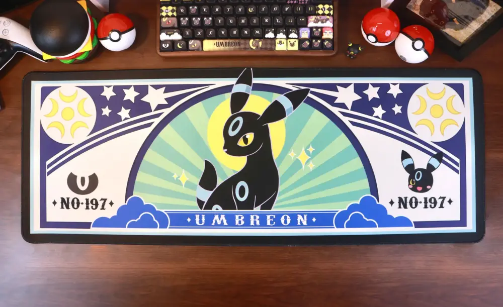 Umbreon gaming desk mat featuring Pokemon 197 and celestial design on a wooden desk.